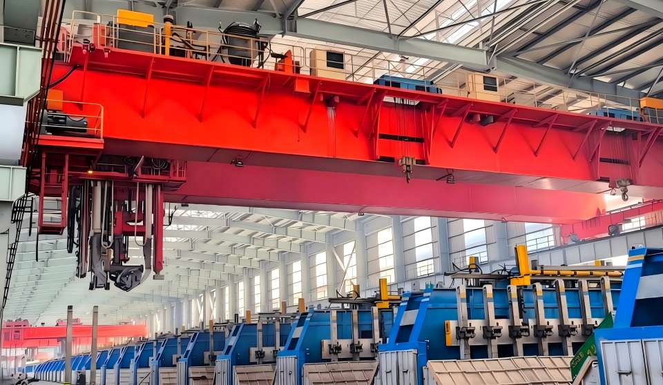 Pot Tending Machine (PTM) overhead crane operating above electrolytic cells in an aluminum smelter.